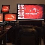 Full Mac and PC desk setup of a cybersecurity professional